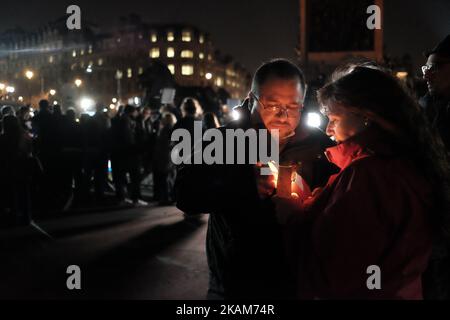 vigil in Trafalgar Square in central London on March 23, 2017 in solidarity with the victims of the March 22 terror attack at the British parliament and on Westminster Bridge. Britain's parliament reopened on Thursday with a minute's silence in a gesture of defiance a day after an attacker sowed terror in the heart of Westminster, killing three people before being shot dead. Sombre-looking lawmakers in a packed House of Commons chamber bowed their heads and police officers also marked the silence standing outside the headquarters of London's Metropolitan Police nearby. (Photo by Jay Shaw Baker Stock Photo