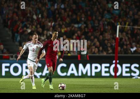 Portugal's forward Cristiano Ronaldo (R) vies with Hungarys defender Adam Lang during the football match between Portugal and Hungary at Luz Stadium in Lisbon on March 25, 2017. (Photo by Carlos Costa/NurPhoto) *** Please Use Credit from Credit Field *** Stock Photo