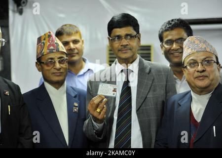 Election Commissioner Ishwori Prasad Paudyal, Chief Election Commissioner Dr. Ayodhee Prasad Yadav and Narendra Dahal showing the voters' identity card after checking at Election Commission Building, Kathmandu, Nepal on Monday, April 03, 2017. The Election Commission has started printing voters' identity cards for upcoming local level election scheduled on May 14, 2017. The Election Commission approved the name of 14.54 million voters for the local level election on Sunday, April 02, 2017. (Photo by Narayan Maharjan/NurPhoto) *** Please Use Credit from Credit Field *** Stock Photo
