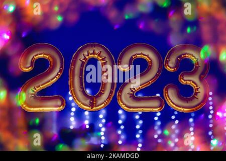 Gold, bronze inflatable foil balloons numbers 2023 on the window against the background of the night city, in neon light. New year 2023, christmas. Celebrating Christmas and New Year 2023. Stock Photo