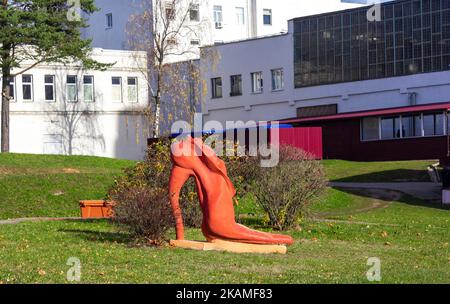 decorative red shoe with high heels, standing on a green lawn Stock Photo