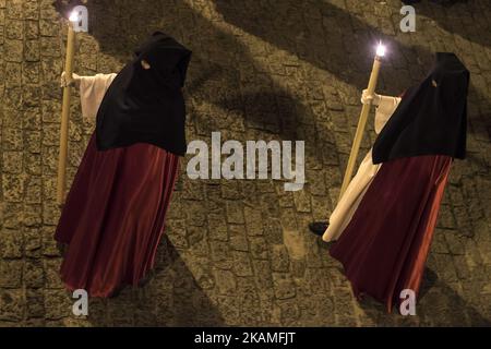 Two members of the brotherhood of the Holy Burial Holy Wednesday at night during the procession of holy mercy that runs through the interior of the cloister of the Cathedral of Santander, on April 12, 2017. The holy Wednesday at night takes place the nocturnal procession of the holy mercy in which the brotherhoods of the brotherhood of the holy burial carrying candles and a passage of holy week with the figure of a recumbent Christ cross the cloister of the cathedral of Santander asi Like the adjacent streets. (Photo by Joaquin Gomez Sastre/NurPhoto) *** Please Use Credit from Credit Field *** Stock Photo