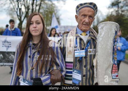 Holocaust survivor Edward Mosberg from New Jersey, USA, and his granddaughter Jordana Karger wearing her grandmother prisoner uniform, walk during the annual March of the Living. Jewish people from Israel and around the world marched the 3km route from Auschwitz to Birkenau, between two formers German Nazi Death Camps, as a silent tribute to all victims of the Holocaust. On Monday, April 24, 2017, in Oswiecim, Poland. Photo by Artur Widak *** Please Use Credit from Credit Field ***  Stock Photo