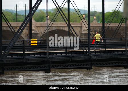 After mounting a one-mile marker a man is seen looking over his shoulder as he continues his way on the Walnut St. Bridge over the Susquehanna River, in Harrisburg, PA, on the morning of April 30, 2017. Diminishing retail, crumbling infrastructure, environmental issues, poverty and unemployment are shown in a view on the current state of a section of rural America on day 101 of Trump's Presidency. The Keystone state Pennsylvania formed an important factor in Trump's victory in the 2016 US elections. (Photo by Bastiaan Slabbers/NurPhoto) *** Please Use Credit from Credit Field *** Stock Photo