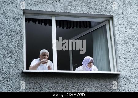 People at the windows watch the 'Revolutionary 1st May' demonstration in the Neukoelln district on May 1, 2017 in Berlin, Germany. May Day, or International Workers' Day, and became in Germany since 1933 a public holiday. May Day has also become known in Berlin for violent clashes between police and demonstrators in particular after 1987, whose 30th anniversary occurs this year. (Photo by Emmanuele Contini/NurPhoto) *** Please Use Credit from Credit Field *** Stock Photo