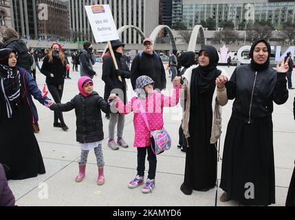 Muslim women and children form a 'circle of peace' during a rally against Islamophobia, White Supremacy & Fascism in downtown Toronto, Ontario, Canada, on May 06, 2017. Protesters clashed with anti-Muslim and fascist groups while hundreds of police officers were deployed to maintain control. Groups such as the Concerned Coalition of Canadian Citizens, the Soldiers of Odin, and the Jewish Defense League blame Muslims for unemployment, austerity and social cuts. (Photo by Creative Touch Imaging Ltd./NurPhoto) *** Please Use Credit from Credit Field *** Stock Photo