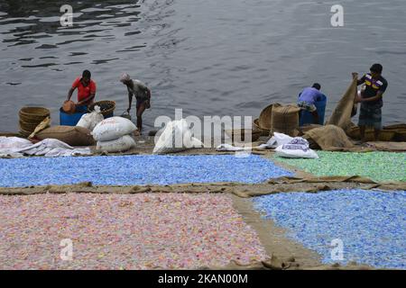 A Bangladeshi worker Recycled plastic chips drying on the bank of the Buriganga River in Dhaka, Bangladesh, on May 7, 2017. These chips will be used for producing various plastic goods. (Photo by Mamunur Rashid/NurPhoto) *** Please Use Credit from Credit Field *** Stock Photo