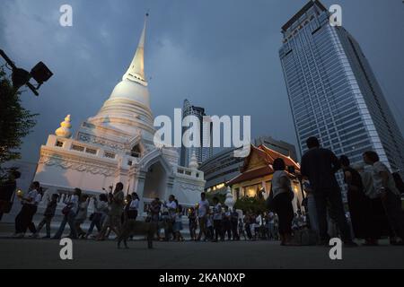 Visakha Bucha, the Buddhist holiday that marks the day of Buddha's birth, death, and day of reaching nirvana, is celebrated at Bangkok's Wat Pathum Wan on May 10th, 2017. Devotees came and offered donations of money and goods in order to make merit, as well as taking part in the tien wian procession at dusk, walking around the inner temple grounds at dusk holding lotus flowers and candles. (Photo Adryel Talamantes/NurPhoto) *** Please Use Credit from Credit Field *** Stock Photo