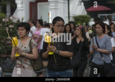 Visakha Bucha, the Buddhist holiday that marks the day of Buddha's birth, death, and day of reaching nirvana, is celebrated at Bangkok's Wat Pathum Wan on May 10th, 2017. Devotees came and offered donations of money and goods in order to make merit, as well as taking part in the tien wian procession at dusk, walking around the inner temple grounds at dusk holding lotus flowers and candles. (Photo Adryel Talamantes/NurPhoto) *** Please Use Credit from Credit Field *** Stock Photo