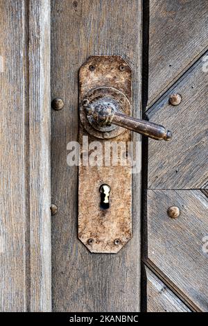 Old wooden door with rusty door handle Stock Photo