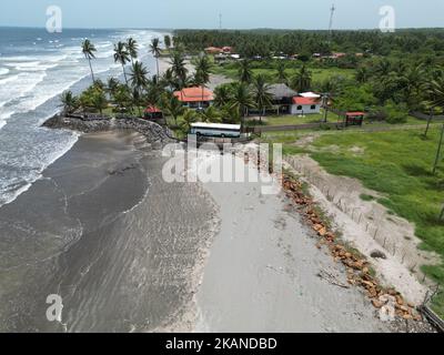 A high angle of the Playa El Espino beach with calm waves and tropical trees on the sandy shore Stock Photo