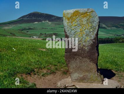 The Craw Stane Class I Pictish symbol stone, Rhynie, Aberdeenshire, Scotland, UK, looking NNW to Tap o' Noth Iron Age hillfort (rear L). Stock Photo