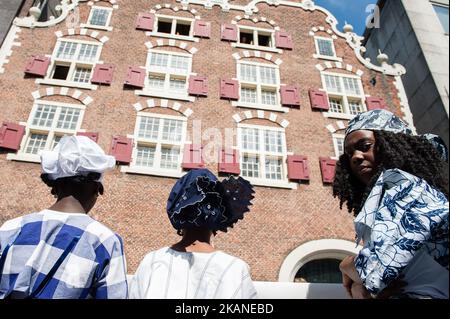 People take part at opening ceremoy 'Keti Koti' of On June 1st 2017 in Amsterdam, Netherland. 1 July 1863 marked freedom for the Surinamese from slavery. Nowhere is that more celebrated than in Amsterdam, home to a thriving Surinamese community and host to the Keti Koti Festival. Keti Koti, meaning 'Broken Chains' in Surinamese, is a free celebration of liberty, equality and solidarity. Ket Koti traditionally is opening with a memorial procession called Memre Waka, around the canal houses of Amsterdam which have a slavery history. The tour ends with word ancestor worship, and the proclamation  Stock Photo