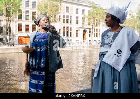People take part at opening ceremoy 'Keti Koti' of On June 1st 2017 in Amsterdam, Netherland. 1 July 1863 marked freedom for the Surinamese from slavery. Nowhere is that more celebrated than in Amsterdam, home to a thriving Surinamese community and host to the Keti Koti Festival. Keti Koti, meaning 'Broken Chains' in Surinamese, is a free celebration of liberty, equality and solidarity. Ket Koti traditionally is opening with a memorial procession called Memre Waka, around the canal houses of Amsterdam which have a slavery history. The tour ends with word ancestor worship, and the proclamation  Stock Photo