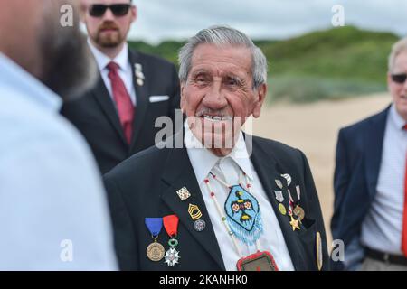 Charles Norman Shay (age 92), a Native American soldier from WWII, returns to Omaha beach for the 73rd anniversary of D-Day. On D-Day 1944, Charles Shay was one of over five hundred North American Indian soldiers who landed on the beaches of Normandy. Shay served in the 1st Infantry Division, 'The Big Red One'. He was only nineteen years old and was a recently drafted medic. Shay was assigned to an assault platoon in the 16th Regiment, and was part of the first wave that landed on June 6 on bloody Omaha Beach under very heavy German fire. 'The Big Red One' sustained about 2,000 casualties on  Stock Photo