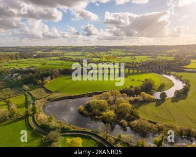 North Yorkshire, UK. UK Weather: A bright sunny day with scattered clouds over Arthington Viaduct and a meandering River Wharfe. Sunshine betraying the autumn season with warm weather. Stock Photo