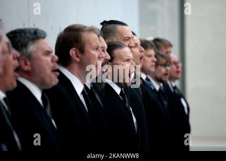 Mieskuoro Huutajat (Screaming Men's Choir) at the SNFCC in Athens, Greece, June 22, 2017. Mieskuoro Huutajat is a Finnish choir founded in 1987 by Petri Sirvio, composer and conductor of the group, that doesn't sing a note. In their signature style, the choir members, decently dressed in black suits, enter their venues in a paramilitary-like manner and begin to scream, bellow and shout excerpts from texts that can range from national anthems and folk songs to children's ditties, poetry and international treaties. (Photo by Giorgos Georgiou/NurPhoto) *** Please Use Credit from Credit Field *** Stock Photo
