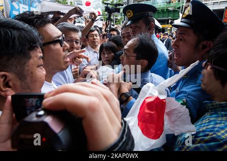 Anti-Abe protesters clash with Japanese police during the speech of Japanese Prime Minister Shinzo Abe for his candidate Aya Nakamura of main opposition, Liberal Democratic Party (LDP) in Akihabara, Tokyo, Japan on July 1, 2017. Tokyo Metropolitan Assembly election will be held on July 2. (Photo by Richard Atrero de Guzman/NurPhoto) *** Please Use Credit from Credit Field *** Stock Photo