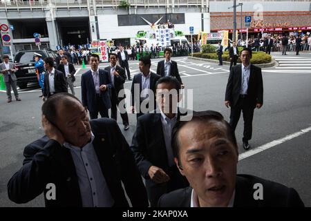 Prime minister's security members were alerted when anti-Abe protesters suddenly gathers in front of an election campaign of main opposition, Liberal Democratic Party (LDP) in Akihabara, Tokyo, Japan on July 1, 2017. During the election campaign for Tokyo Metropolitan Assembly, anti-Abe protesters chant with their placards “Abe wa Yamero!” 'Resign Prime Minister Abe!” during the campaign speech of PM Shinzo Abe for his candidate Aya Nakamura. (Photo by Richard Atrero de Guzman/NurPhoto) *** Please Use Credit from Credit Field *** Stock Photo