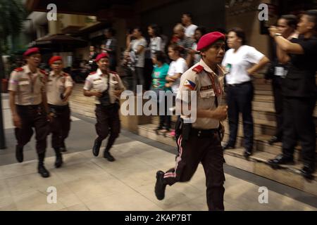 Local enforcers run along a street during an anti-terrorism drill in Pasig City, east of Manila, Philippines on July 14, 2017. The local government of Pasig City held its first anti-terrorism drill to showcase its capabilities in the event of a terrorist attack in the city. (Photo by Richard James Mendoza/NurPhoto) *** Please Use Credit from Credit Field *** Stock Photo