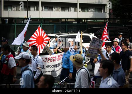 Japanese nationalists holding Japanese maritime flags, escorted by police, took to the streets in a "hate demonstration" in Akihabara, Tokyo, Japan on July 16, 2017. The nationalists faced off with anti-racist groups who mounted counter protests demanding an end to hate speech and racism in Japan. (Photo by Richard Atrero de Guzman/NUR Photo) *** Please Use Credit from Credit Field *** Stock Photo