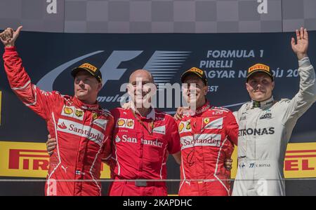 Race winner Sebastian Vettel of Germany and Ferrari celebrates with second place Kimi Raikkonen of Finland and Ferrari, third place Valtteri Bottas of Finland and Mercedes GP and Jock Clear, Head of Engineering, Scuderia Ferrari on the podium during the Formula One Grand Prix of Hungary at Hungaroring on July 30, 2017 in Budapest, Hungary. (Photo by Robert Szaniszló/NurPhoto) *** Please Use Credit from Credit Field *** Stock Photo
