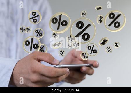 A man presenting 3D rendered percentage signs above the smartphone screen in his hands Stock Photo