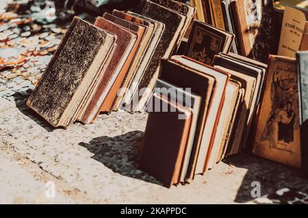 Old books are stacked in rows. Sale of vintage books. Side view Stock Photo
