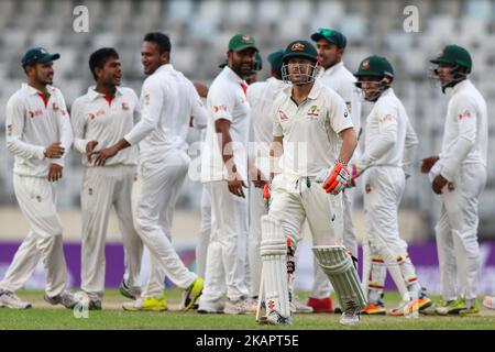 Bangladesh's Mehedi Hasan Miraz, second left, celebrate with his teammates after the dismissal of Australia's David Warner, third right, during day one of the First Test match between Bangladesh and Australia at Shere Bangla National Stadium on August 27, 2017 in Mirpur, Bangladesh. (Photo by Ahmed Salahuddin/NurPhoto) Stock Photo