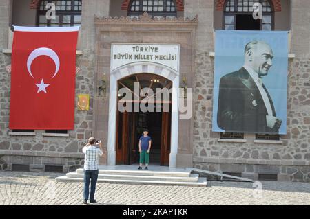A father takes pictures of his son in front of first building of the Turkish Grand National Assembly (TBMM) in the historic Ulus district of Ankara, Turkey on August 29, 2017 as Turkish citizens prepare to celebrate the 95th anniversary of the Victory Day on August 30. (Photo by Altan Gocher/NurPhoto) Stock Photo