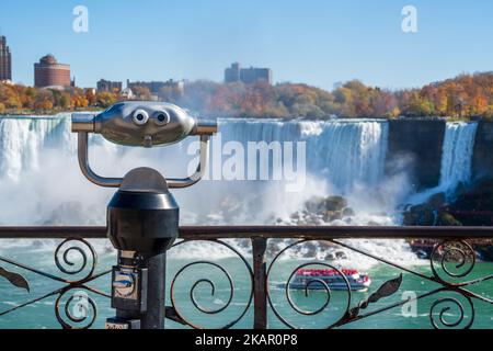 Coin operated binocular viewer telescope. American Falls in autumn foliage season. Niagara Falls City, Ontario, Canada. Stock Photo