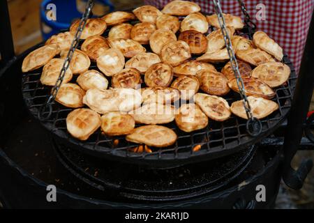 Oscypek, a smoked cheese made from salted sheeps milk is seen being grilled at the Festival of the Plums on 3 September, 2017. Once the pieces are grilled they can be eaten with plum jam which combines well with the salty, smoked flavour of the grilled cheese. (Photo by Jaap Arriens/NurPhoto) Stock Photo