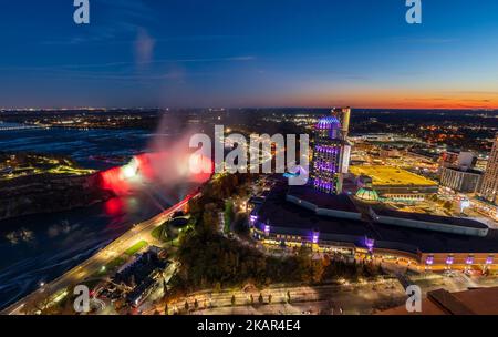 Aerial view of Horseshoe Falls in twilight time. Niagara Falls City downtown illumination. Stunning landscape at night. Stock Photo