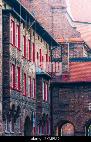 the historic Nikiszowiec housing estate. Traditional Silesian buildings. White windows with a red border Stock Photo