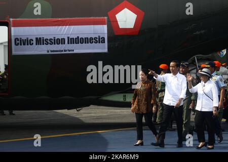 From L-R, front: Indonesia's Coordinating Minister for Human Development and Cultural Affairs Puan Maharani, Indonesia's President Joko Widodo, and Indonesia's Foreign Minister Retno Marsudi walk on the tarmac as Indonesian soldiers load sacks of government food aid onto an air force C-130 aircraft, bound for Bangladesh and its cargo destined for Rohingya refugees fleeing violence in Myanmar, at the Halim Perdanakusuma airport in Jakarta on September 13, 2017. UN's National Security Council plans to meet September 13 to discuss the Rohingya refugee crisis, which continues to deepen as the numb Stock Photo
