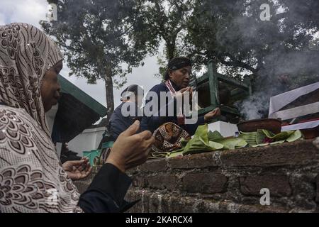 Javanese people follows the ritual of Nguras Enceh ceremony in the complex of the Tomb Kings Mataram at Yogyakarta, Indonesia, on September 22, 2017. Enceh drained a procession drain and fill the water back four enceh (big barrel) which is held every month of Muharram (Islamic calendar) or Suro (Javanese calendar) by the courtiers as known as abdi dalem of the Sultanate of Yogyakarta and Surakarta. Water from big barrel was then grabs by the pilgrims are believed to give a blessing and cure the disease. Nguras Enceh ceremony tradition has a meaning discard the bad things and replace them with  Stock Photo