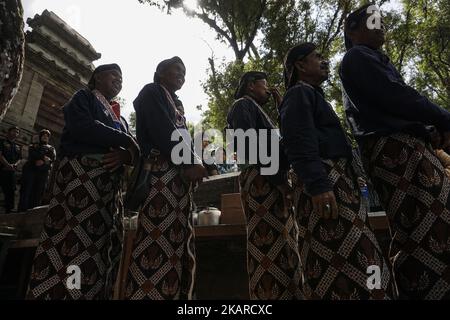 Javanese people follows the ritual of Nguras Enceh ceremony in the complex of the Tomb Kings Mataram at Yogyakarta, Indonesia, on September 22, 2017. Enceh drained a procession drain and fill the water back four enceh (big barrel) which is held every month of Muharram (Islamic calendar) or Suro (Javanese calendar) by the courtiers as known as abdi dalem of the Sultanate of Yogyakarta and Surakarta. Water from big barrel was then grabs by the pilgrims are believed to give a blessing and cure the disease. Nguras Enceh ceremony tradition has a meaning discard the bad things and replace them with  Stock Photo