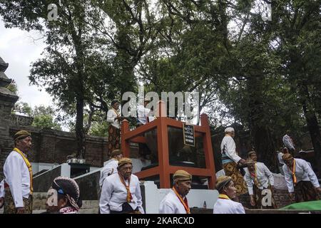 Javanese people follows the ritual of Nguras Enceh ceremony in the complex of the Tomb Kings Mataram at Yogyakarta, Indonesia, on September 22, 2017. Enceh drained a procession drain and fill the water back four enceh (big barrel) which is held every month of Muharram (Islamic calendar) or Suro (Javanese calendar) by the courtiers as known as abdi dalem of the Sultanate of Yogyakarta and Surakarta. Water from big barrel was then grabs by the pilgrims are believed to give a blessing and cure the disease. Nguras Enceh ceremony tradition has a meaning discard the bad things and replace them with  Stock Photo