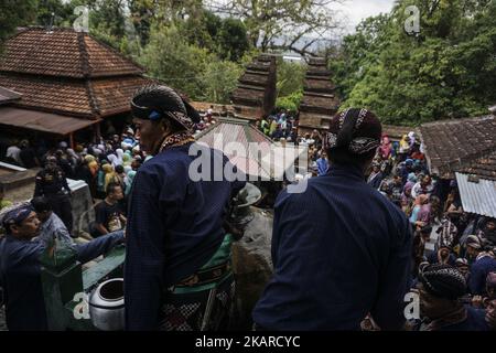 Javanese people follows the ritual of Nguras Enceh ceremony in the complex of the Tomb Kings Mataram at Yogyakarta, Indonesia, on September 22, 2017. Enceh drained a procession drain and fill the water back four enceh (big barrel) which is held every month of Muharram (Islamic calendar) or Suro (Javanese calendar) by the courtiers as known as abdi dalem of the Sultanate of Yogyakarta and Surakarta. Water from big barrel was then grabs by the pilgrims are believed to give a blessing and cure the disease. Nguras Enceh ceremony tradition has a meaning discard the bad things and replace them with  Stock Photo