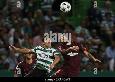 Barcelona midfielder Sergio Busquets heads the ball over AC Milan  midfielder Kevin Prince Boateng, of Ghana, during a Champions League first  leg quarterfinals soccer match, between AC Milan and Barcelona, at the