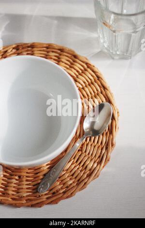 Empty white bowl and spoon Stock Photo