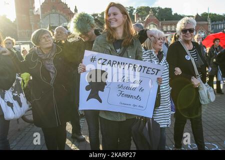Woman holding banner, that speaks - Black protest - we all should be feminists - is seen in Gdansk, Poland on 3 October 2017 Demonstration, organized by the group Ratujmy Kobiety (Save Women), aims to show ruling party PiS , that the womens rights movement remains alive and strong and will continue to oppose plans to totally ban abortion in Poland. (Photo by Michal Fludra/NurPhoto) Stock Photo