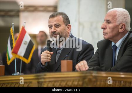 Senior Fatah official Azzam al-Ahmad, and Hamas' representative, Saleh al-Arouri, sign a reconciliation deal during a short ceremony at the Egyptian intelligence complex in Cairo, Egypt on October 12, 2017. Thursday's signing came after two days of negotiations in the Egyptian capital on the governing of the Gaza Strip as part of the most serious effort to date to end the 10 year rift between the rival Palestinian groups. (Photo by Ibrahim Ezzat/NurPhoto) Stock Photo