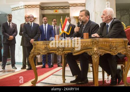 Senior Fatah official Azzam al-Ahmad, and Hamas' representative, Saleh al-Arouri, sign a reconciliation deal during a short ceremony at the Egyptian intelligence complex in Cairo, Egypt, Thursday, Oct. 12, 2017. Thursday's signing came after two days of negotiations in the Egyptian capital on the governing of the Gaza Strip as part of the most serious effort to date to end the 10 year rift between the rival Palestinian groups. (Photo by Ibrahim Ezzat/NurPhoto) Stock Photo