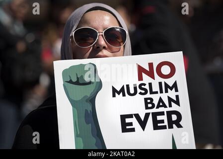 An activist holds a sign during a protest against President Trump's travel ban in Los Angeles, California on October 15, 2017. The No Muslim Ban Ever rally was organized by the Council on American-Islamic Relations in response to the Trump administration’s third iteration of the of the travel ban. (Photo by Ronen Tivony/NurPhoto) Stock Photo