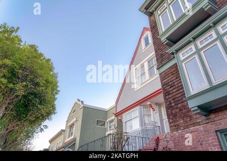 Houses in the neighborhood of San Francisco, California. There is a house in the middle with railings at the front beside the house on the right with Stock Photo