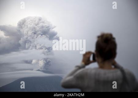 Citizens evacuate and brace for the Mount Agung eruption in Bali, Karang Asem, Indonesia on November 28, 2017. Since the increasing level to level 4 which is the highest status alert, eruption of Mount Agung already covering some area of Bali with ashes, the closing of airport, and total of 38 thousands of refugee. Cold larva also hit some river near karang asem giving brown color to the river and strong sulfur smell. (Photo by Donal Husni/NurPhoto) Stock Photo