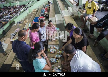 Citizens evacuate and brace for the Mount Agung eruption in Bali, Karang Asem, Indonesia on November 28, 2017. Since the increasing level to level 4 which is the highest status alert, eruption of Mount Agung already covering some area of Bali with ashes, the closing of airport, and total of 38 thousands of refugee. Cold larva also hit some river near karang asem giving brown color to the river and strong sulfur smell. (Photo by Donal Husni/NurPhoto) Stock Photo