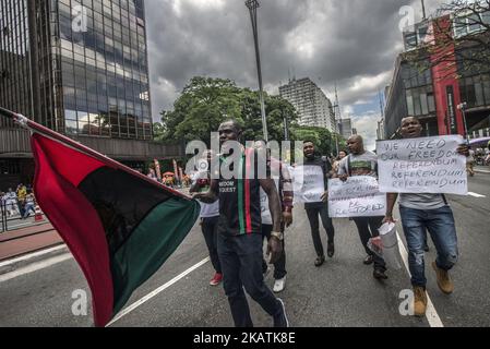 Demonstrators participate in the March of Immigrants on Avenida Paulista in Sao Paulo, Brazil, on 3 December 2017. They march in favor of the visibility of immigrants as subjects of rights, highlighting its socioeconomic, cultural and historical importance in the development of Brazilian society. The march is part of the worldwide mobilization of immigrants instituted by the UN on 18/12/1990. (Photo by Cris Faga/NurPhoto) Stock Photo