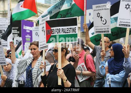 Protestors hold signs during a demonstration in Toronto, Canada on July 29, 2017, to protest against Israel and to show solidarity with Palestine. Israel had angered Muslims by installing metal detectors and security cameras after a July 14 attack near the Al-Aqsa Mosque holy site in Jerusalem, known to Jews as the Temple Mount, in which gunmen killed two policemen. The move sparked Muslim protests and deadly unrest, and the Israeli government removed the detectors on July 25 as well as the cameras. (Photo by Creative Touch Imaging Ltd./NurPhoto) Stock Photo